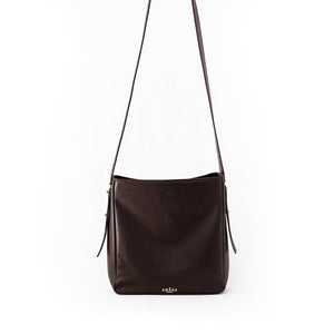 Amana Carla Cross-body Bag front view. Black smooth lamb leather bag with beautiful gold hardware details for an elegant finish. Gold zip closure at top of bag, gold zip detail pocket at back, 4 leather insert pockets and zip pocket in inerior, adjustable cross-body strap.