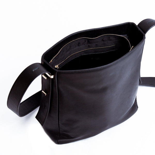 Amana Carla Cross-body Bag interior view. Black smooth lamb leather bag with gold zip closure at top of bag and 4 leather insert pockets and zip pocket in inerior.