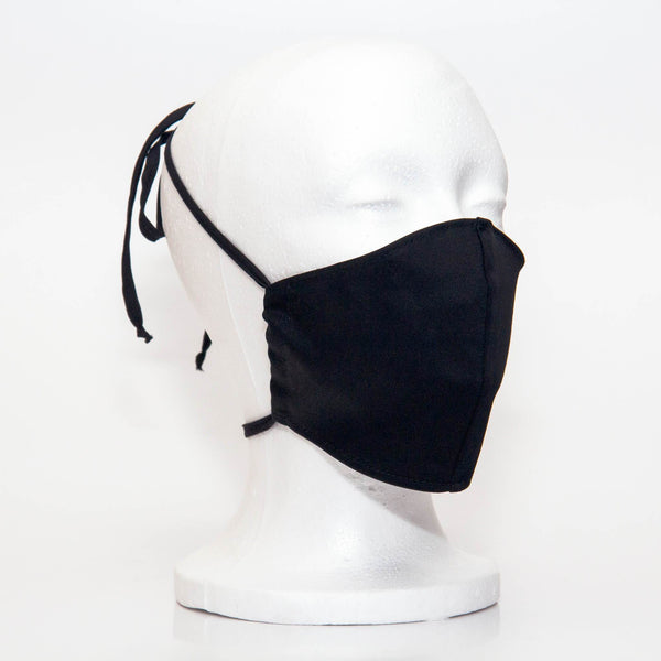 Black Alpha Mask Side View: Solid black colour fabric face mask contoured to fit comfortably on your face. This is a 3 layer fabric mask with a middle pocket to insert the filter as the third layer. The bias binding straps is easily adjustable for your comfort and ties behind your head. This mask has a removable filter. This mask an unisex adult fit.