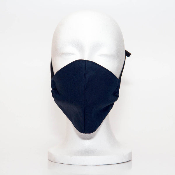 Navy Alpha Mask Front View: Solid navy colour fabric face mask contoured to fit comfortably on your face. This is a 3 layer fabric mask with a middle pocket to insert the filter as the third layer. The bias binding straps is easily adjustable for your comfort and ties behind your head. This mask has a removable filter. This mask an unisex adult fit.