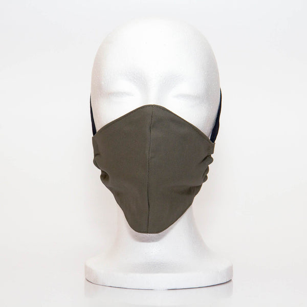 Olive Alpha Mask Front View: Solid olive colour fabric face mask contoured to fit comfortably on your face. This is a 3 layer fabric mask with a middle pocket to insert the filter as the third layer. The bias binding straps is easily adjustable for your comfort and ties behind your head. This mask has a removable filter. This mask an unisex adult fit.