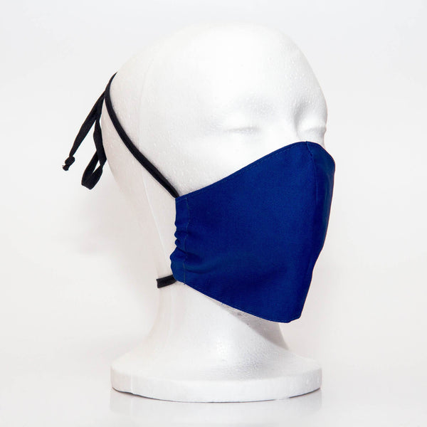 Cobalt Alpha Mask Side View: Solid cobalt colour fabric face mask contoured to fit comfortably on your face. This is a 3 layer fabric mask with a middle pocket to insert the filter as the third layer. The bias binding straps is easily adjustable for your comfort and ties behind your head. This mask has a removable filter. This mask an unisex adult fit.