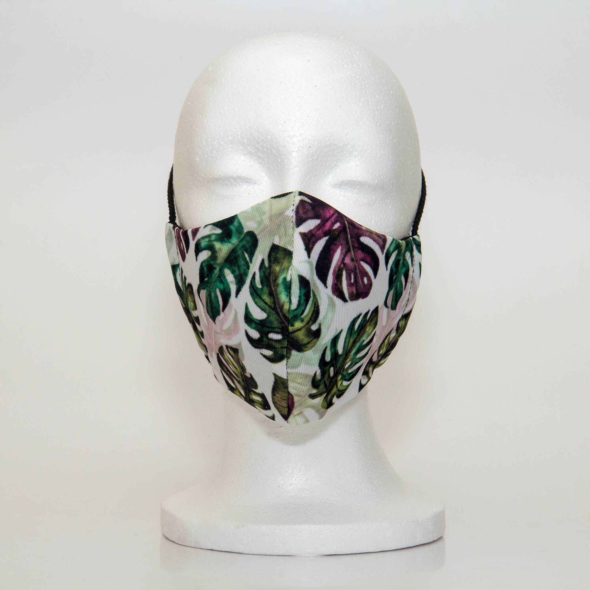 Oltre Print Mask Front View: Multicolour leaves print.The multicolour monstera leaves print bring a beautiful tropical feel to the mask. 3 Layer fabric mask with a middle filter layer that is contoured to fit comfortably on your face. Mask will fit women and teen girls.