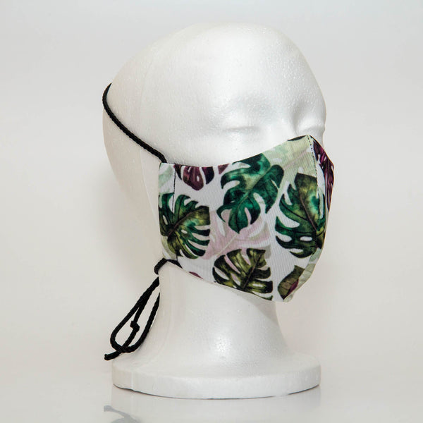 Oltre Print Mask Side View: Multicolour leaves print. The soft woven strap is easily adjustable around your head for your comfort. 3 Layer fabric mask with a middle filter layer that is contoured to fit comfortably on your face. Mask will fit women and teen girls.