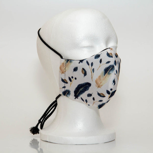 Oltre Print Mask Side View: Blue Feathers print. The soft woven strap is easily adjustable around your head for your comfort. 3 Layer fabric mask with a middle filter layer that is contoured to fit comfortably on your face. Mask will fit women and teen girls.