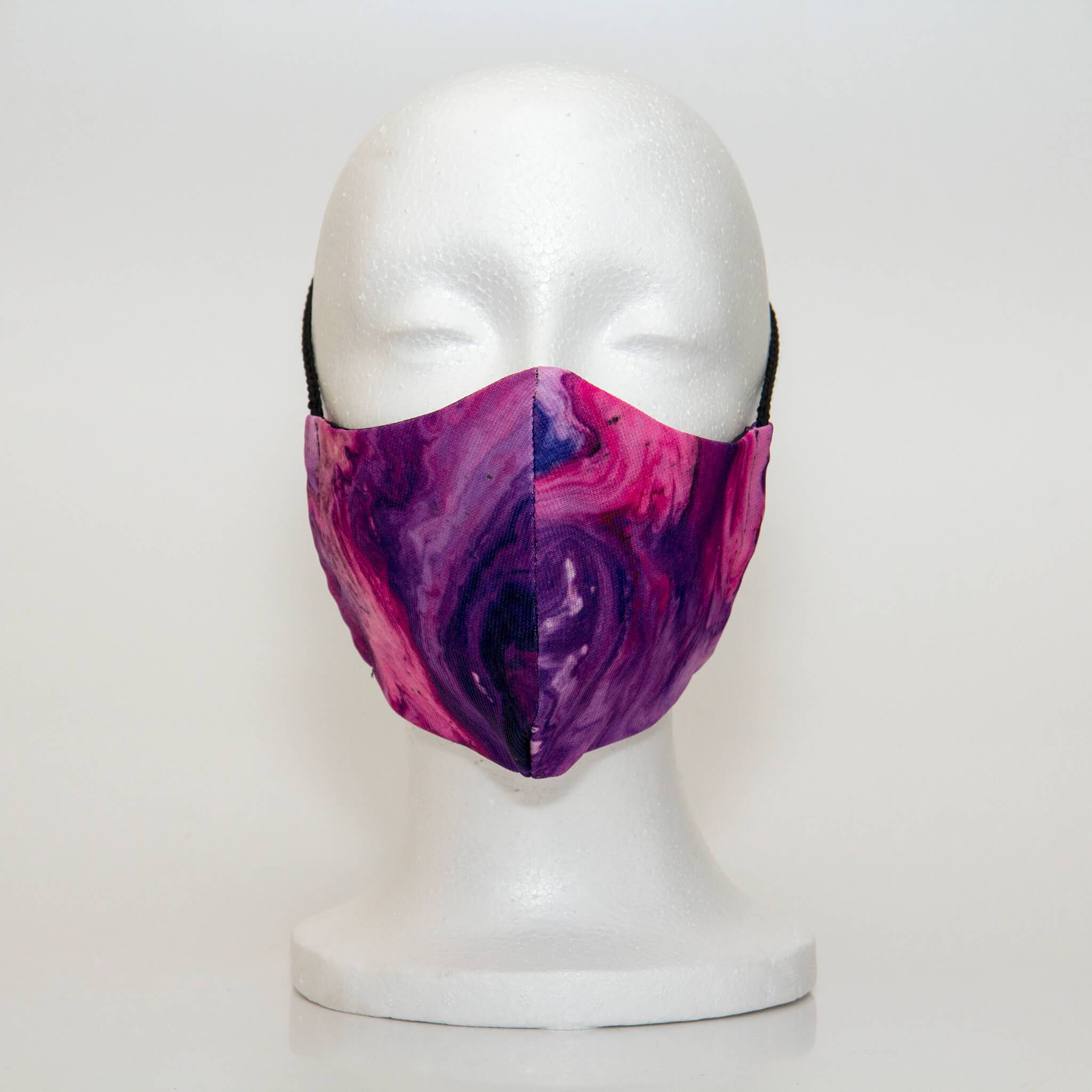 Oltre Print Mask Front View: Multicolour marble print. The strinking pink, orange, and purple marble-effect print is pretty, fun and trendy. 3 Layer fabric mask with a middle filter layer that is contoured to fit comfortably on your face. Mask will fit women and teen girls.