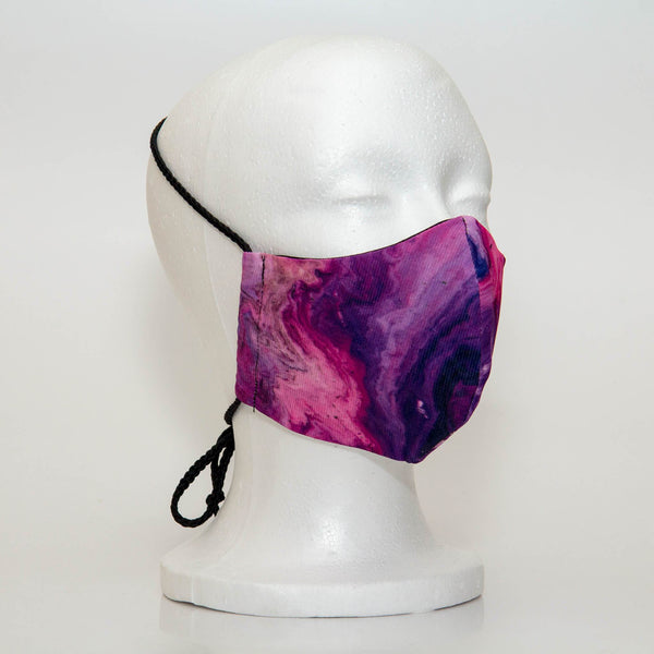 Oltre Print Mask Side View: Multicolour Marble print. The soft woven strap is easily adjustable around your head for your comfort. 3 Layer fabric mask with a middle filter layer that is contoured to fit comfortably on your face. Mask will fit women and teen girls.