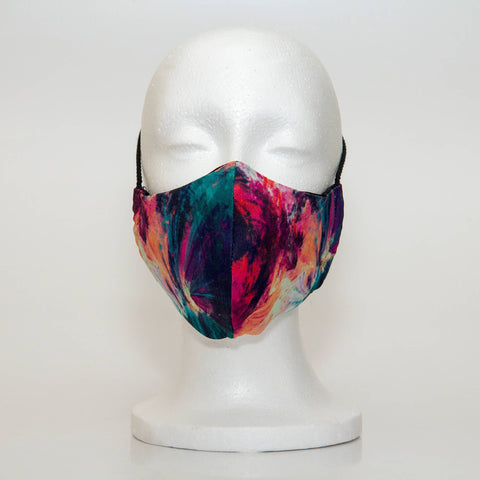 Oltre Print Mask Front View: Teal & Pink Abstract print. The abstract splashes of bold and feminine colours is a striking combination for the daring women. 3 Layer fabric mask with a middle filter layer that is contoured to fit comfortably on your face. Mask will fit women and teen girls.
