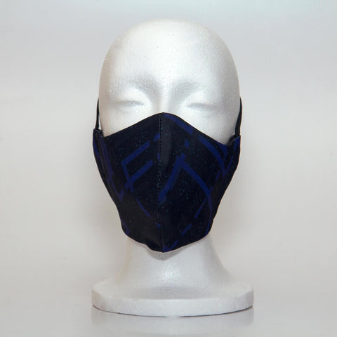 Oltre Print Mask Front View: Black & Blue print. A subtle and professional black and cobalt blue print for your office and out-and-about looks. 3 Layer fabric mask with a middle filter layer that is contoured to fit comfortably on your face. Mask will fit men.