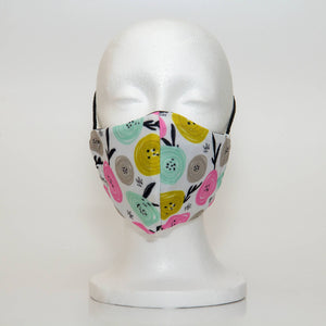 Oltre Print Mask Front View: Multicolour swirls print. The funky multicolour circles make you think of happy apples. The pretty colour combination of yellow, pink, blue and grey is youthful and fun. 3 Layer fabric mask with a middle filter layer that is contoured to fit comfortably on your face. Mask will fit women and teen girls.