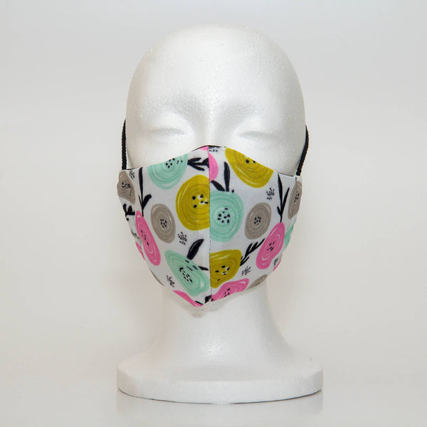 Oltre Print Mask Front View: Multicolour swirls print. The funky multicolour circles make you think of happy apples. The pretty colour combination of yellow, pink, blue and grey is youthful and fun. 3 Layer fabric mask with a middle filter layer that is contoured to fit comfortably on your face. Mask will fit women and teen girls.