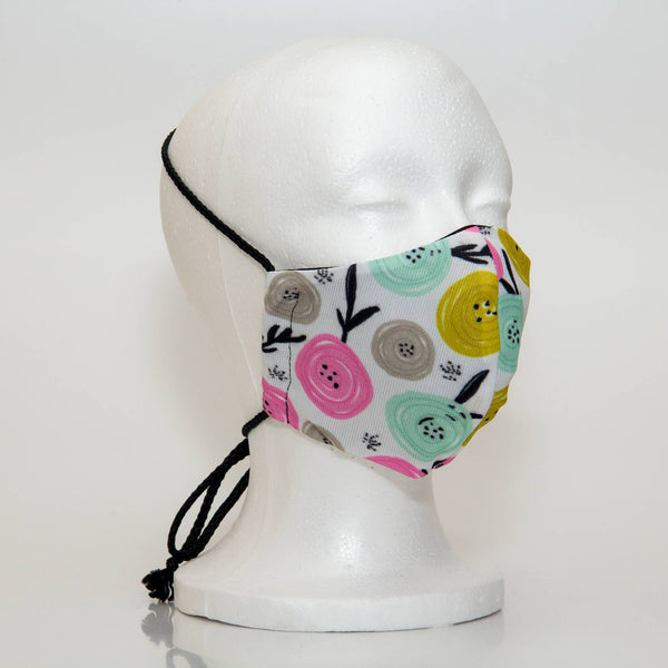 Oltre Print Mask Side View: Multicolour swirls print. The soft woven strap is easily adjustable around your head for your comfort. 3 Layer fabric mask with a middle filter layer that is contoured to fit comfortably on your face. Mask will fit women and teen girls.