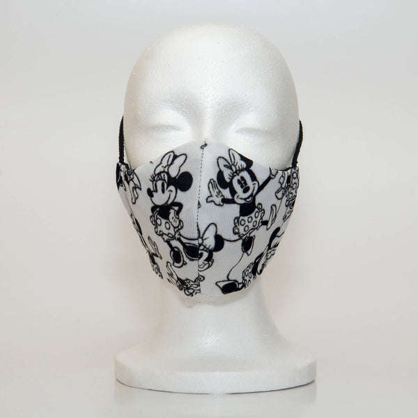 Oltre Print Mask Front View: Minnie Mouse print. Minnie Mouse mask is for your inner Disney lover. 3 Layer fabric mask with a middle filter layer that is contoured to fit comfortably on your face. Mask will fit women and teen girls.