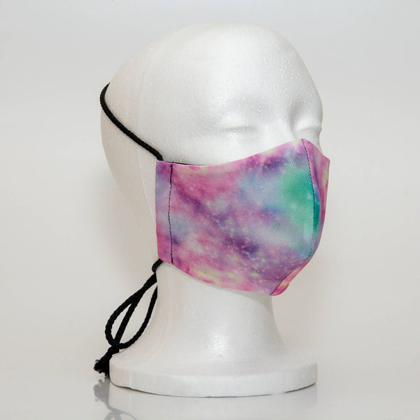 Oltre Print Mask Side View: Cotton Candy print. The soft woven strap is easily adjustable around your head for your comfort. 3 Layer fabric mask with a middle filter layer that is contoured to fit comfortably on your face. Mask will fit women and teen girls.