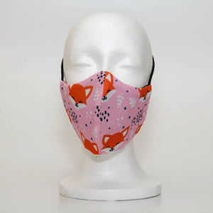 Oltre Print Mask Front View: Pink Foxes print. Our pink fox print is charming and playful, an attractive combination for the mischievous women. 3 Layer fabric mask with a middle filter layer that is contoured to fit comfortably on your face. Mask will fit women and teen girls.