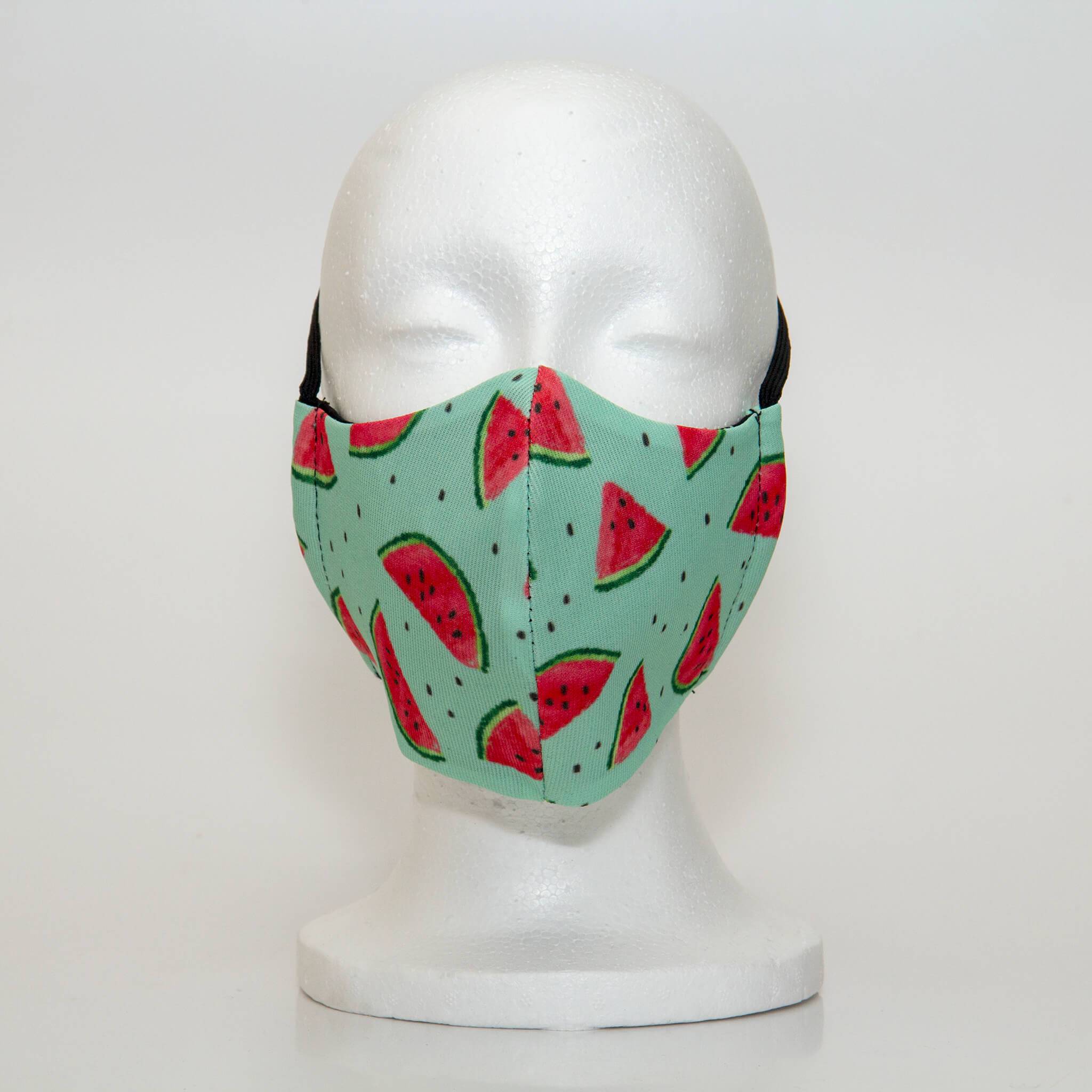 Oltre Print Mask Front View: Watermelon print. Our juicy, fruity watermelon print is bright and playful and a bold, cheerful addition to your outfit. 3 Layer fabric mask with a middle filter layer that is contoured to fit comfortably on your face. Mask will fit women and teen girls.