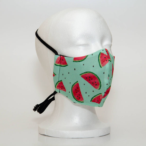 Oltre Print Mask Side View: Watermelon print. The soft woven strap is easily adjustable around your head for your comfort. 3 Layer fabric mask with a middle filter layer that is contoured to fit comfortably on your face. Mask will fit women and teen girls.