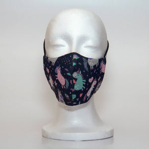 Oltre Print Mask Front View: Unicorns print. The mythical hand-drawn unicorn print is adorable with touches of rainbow colour elements.. 3 Layer fabric mask with a middle filter layer that is contoured to fit comfortably on your face. Mask will fit pre school girls between 3 to 6 years old.