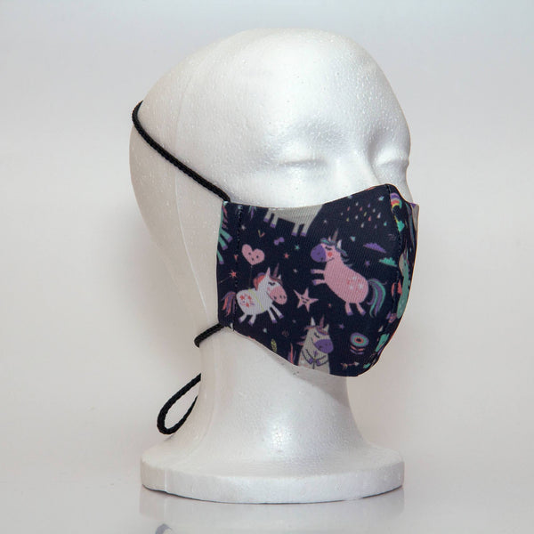 Oltre Print Mask Side View: Unicorns print. The soft woven strap is easily adjustable around your head for your comfort. 3 Layer fabric mask with a middle filter layer that is contoured to fit comfortably on your face. Mask will fit pre-teen girls between 7 to 12 years old.