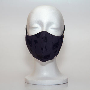 Oltre Print Mask Front View: Batman print. This is a fun and subtle batman print for your inner Batman. 3 Layer fabric mask with a middle filter layer that is contoured to fit comfortably on your face. Mask will fit pre-teen boys between 7 to 12 years old.