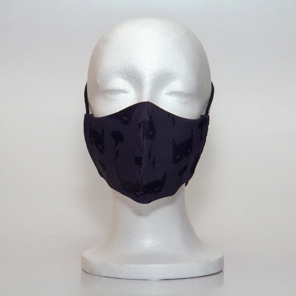 Oltre Print Mask Front View: Batman print. This is a fun and subtle batman print for your inner Batman. 3 Layer fabric mask with a middle filter layer that is contoured to fit comfortably on your face. Mask will fit pre school boys between 3 to 6 years old.