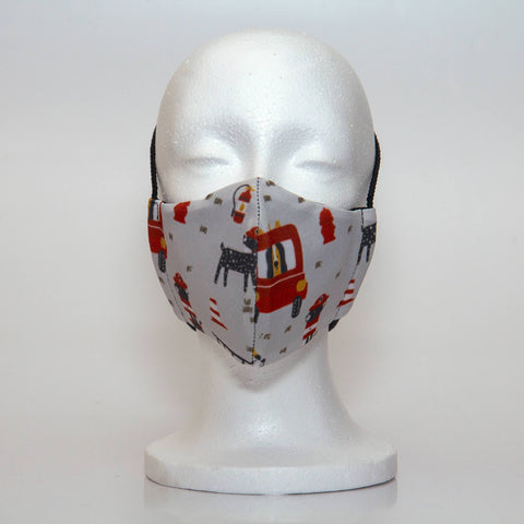 Oltre Print Mask Front View: Red Firetrucks print. Our red firetrucks with dalmations will grab your imagination for playtime. 3 Layer fabric mask with a middle filter layer that is contoured to fit comfortably on your face. Mask will fit pre-teen boys between 7 to 12 years old.